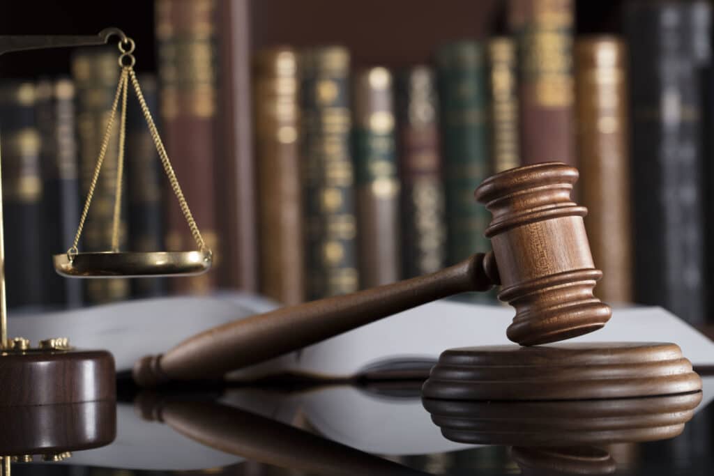 Justice concept A judge's gavel & the scales of justice behind it